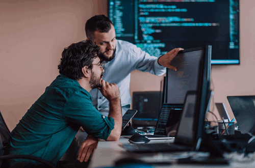 two colleagues working together in front of computer 